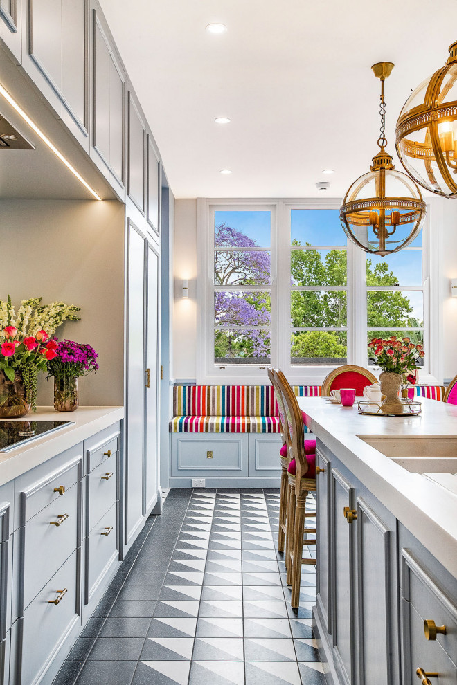 Mid-sized eclectic galley separate kitchen in Sydney with a double-bowl sink, beaded inset cabinets, blue cabinets, quartz benchtops, white splashback, ceramic floors, with island and white benchtop.