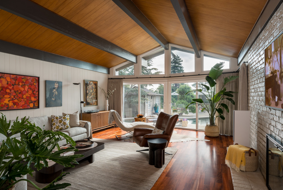 Photo of a large midcentury open plan games room in San Francisco with dark hardwood flooring, a wood ceiling and panelled walls.