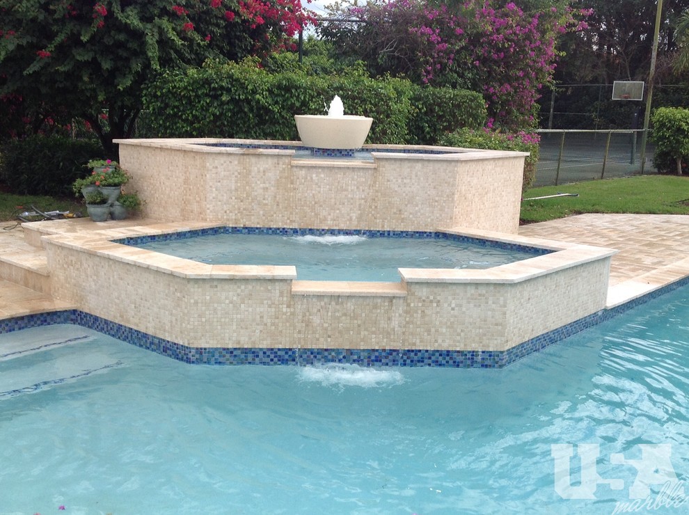 Large mountain style stone aboveground pool photo in Miami
