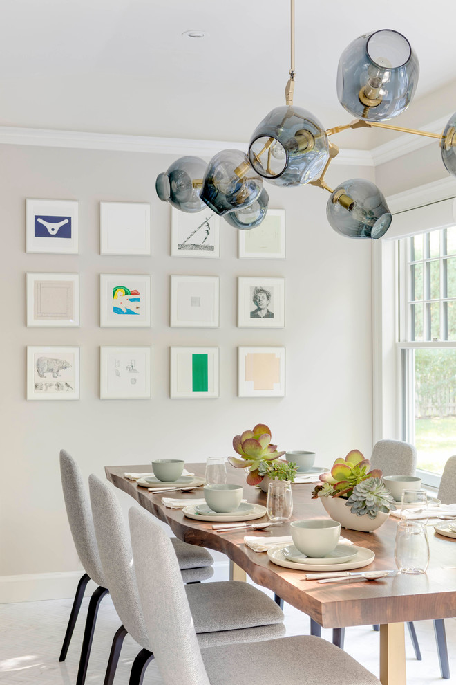 Inspiration for a transitional dining room in Boston with beige walls and white floor.