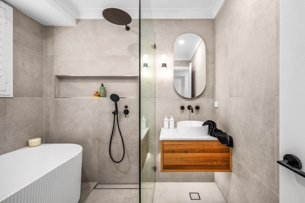 Design ideas for a mid-sized contemporary master wet room bathroom in Central Coast with flat-panel cabinets, medium wood cabinets, a freestanding tub, gray tile, grey walls, a vessel sink, green floor, an open shower, white benchtops, a niche, a single vanity and a floating vanity.