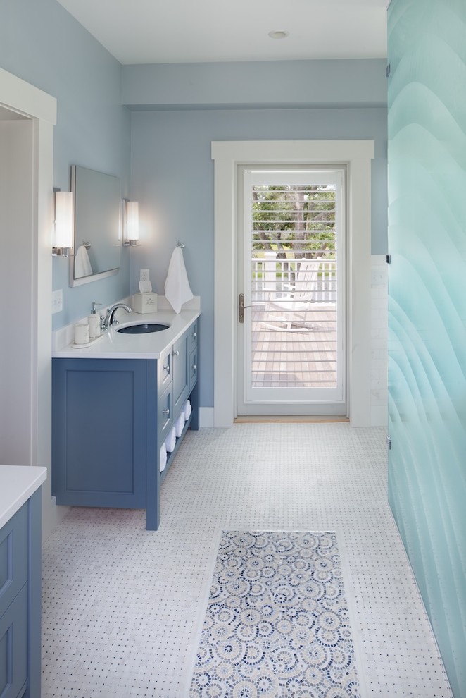 Inspiration for a large beach style master bathroom in DC Metro with an undermount sink, white cabinets, a freestanding tub, an open shower, blue tile, ceramic tile, blue walls, mosaic tile floors and recessed-panel cabinets.