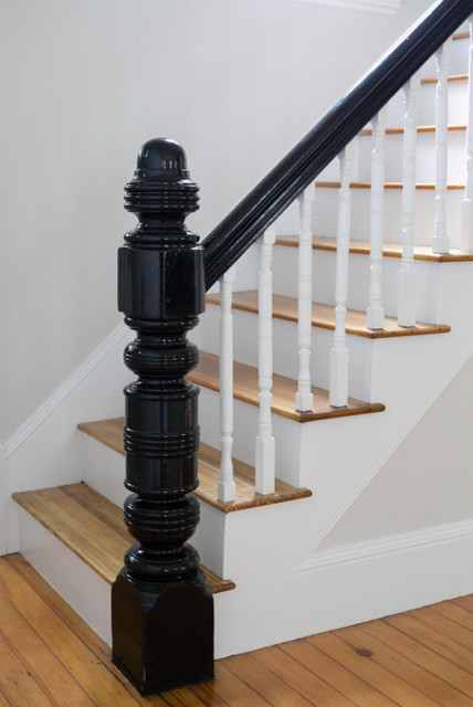Mid-sized transitional wood l-shaped staircase in Manchester with painted wood risers and wood railing.