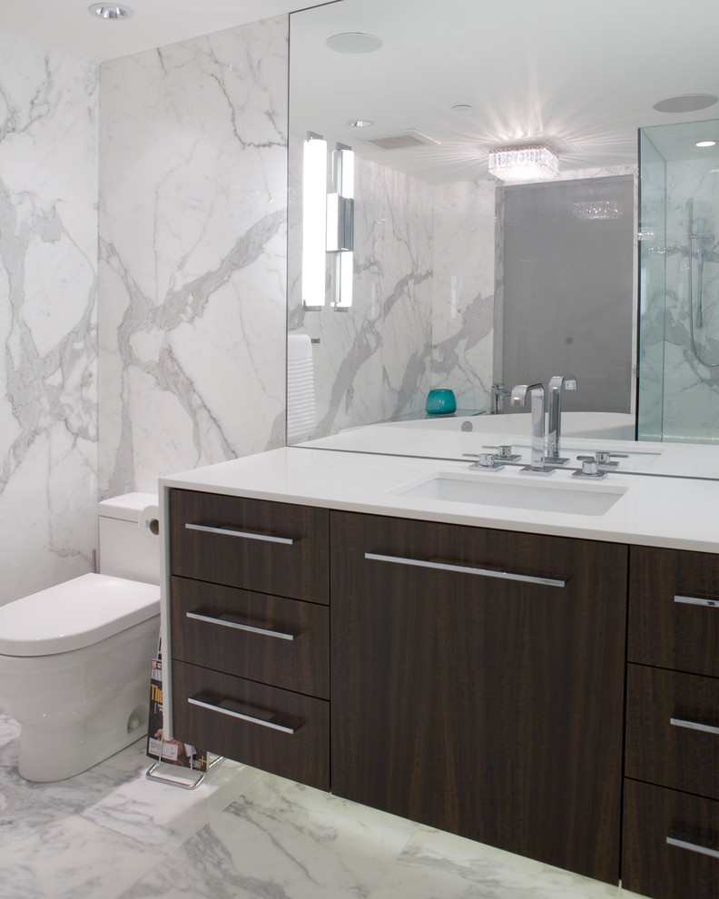 Design ideas for a mid-sized contemporary 3/4 bathroom in Vancouver with flat-panel cabinets, dark wood cabinets, a freestanding tub, a corner shower, a one-piece toilet, gray tile, multi-coloured tile, white tile, stone slab, multi-coloured walls, marble floors and an undermount sink.
