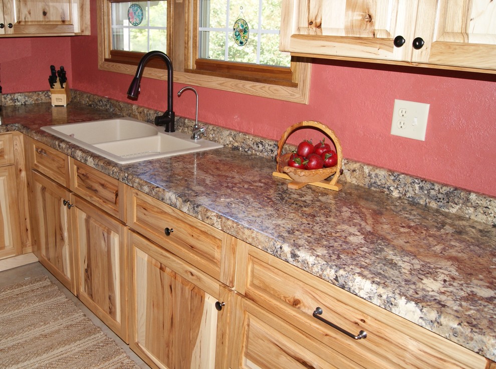 Enclosed kitchen - mid-sized rustic u-shaped travertine floor enclosed kitchen idea with a drop-in sink, raised-panel cabinets, light wood cabinets, granite countertops, white appliances and a peninsula