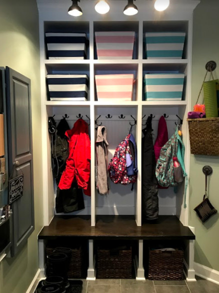 Example of a small transitional porcelain tile and beige floor mudroom design with green walls