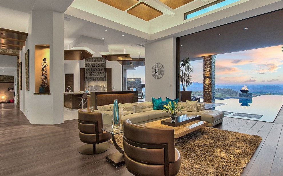 Example of a southwest formal and open concept brown floor living room design in Phoenix with gray walls