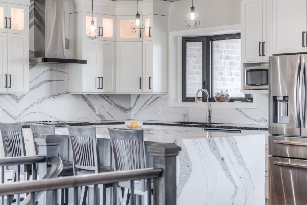 Inspiration for a transitional eat-in kitchen remodel with shaker cabinets, white cabinets, stainless steel appliances and an island