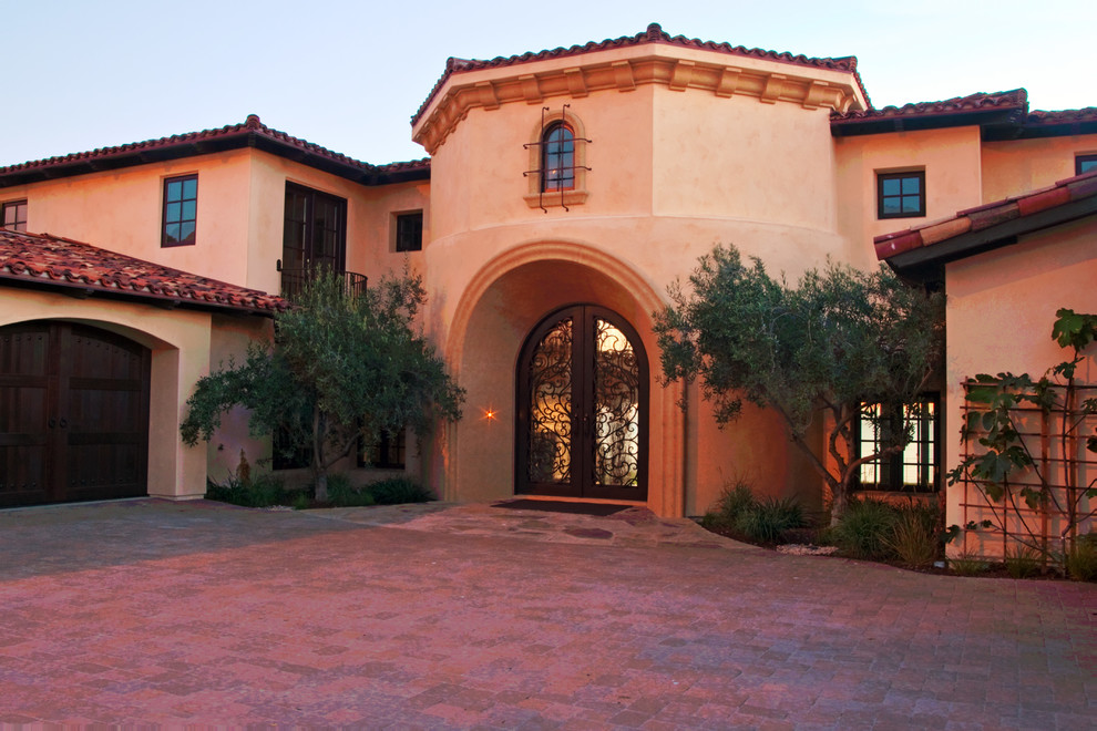 Design ideas for a mediterranean two-storey stucco beige exterior in San Luis Obispo.