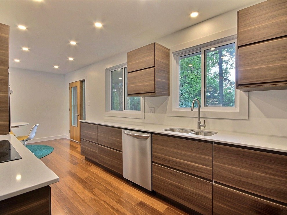Inspiration for a contemporary eat-in kitchen in Toronto with a double-bowl sink, flat-panel cabinets, dark wood cabinets, quartz benchtops, stainless steel appliances, bamboo floors and brown floor.