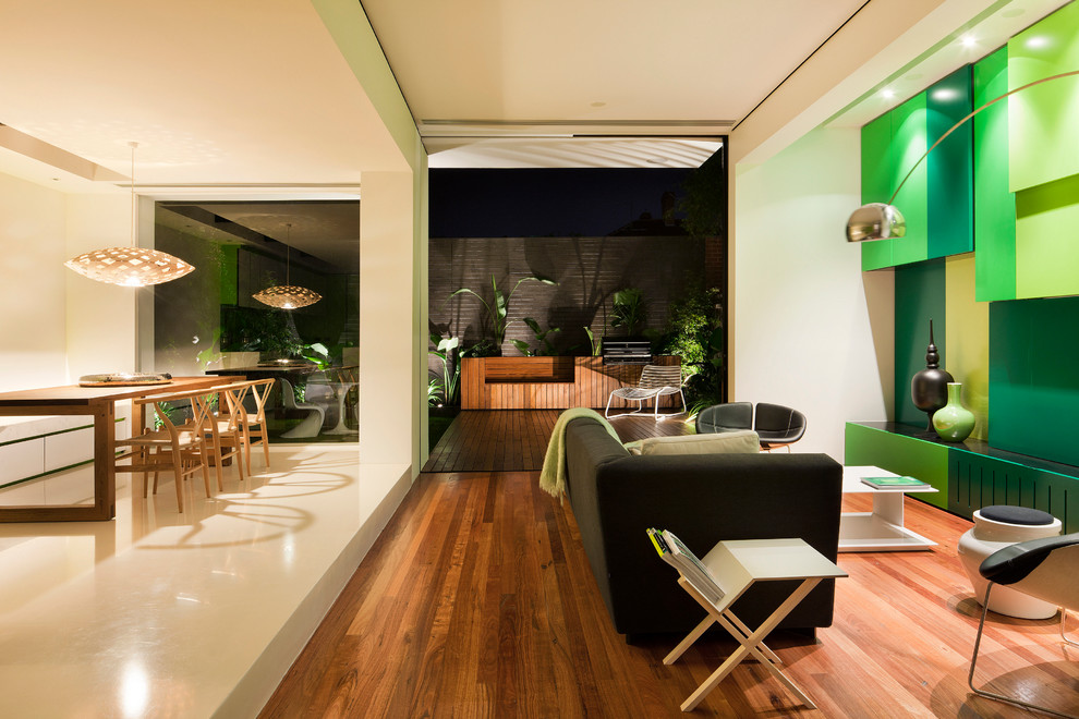 Photo of a mid-sized contemporary open concept living room in Melbourne with white walls and medium hardwood floors.