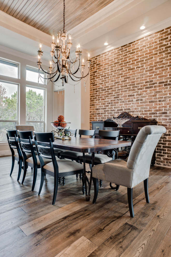 Large country open plan dining in Dallas with white walls, brown floor, wood and brick walls.