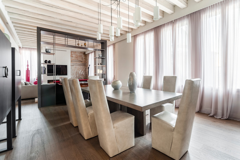 Contemporary open plan dining in Venice with beige walls, medium hardwood floors, no fireplace and brown floor.