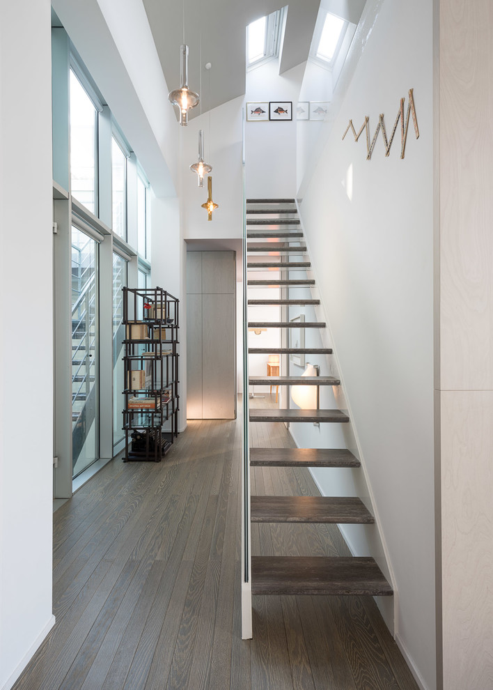 Inspiration for a contemporary wood straight staircase in Milan with open risers.