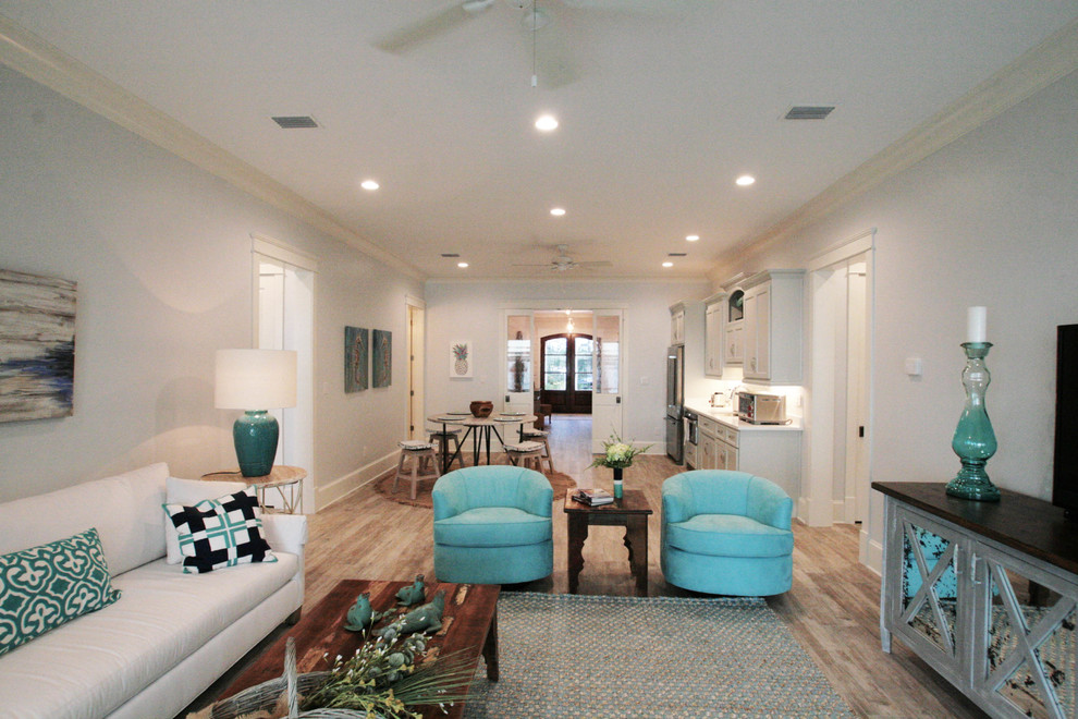 Photo of a large beach style hallway with white walls and dark hardwood floors.