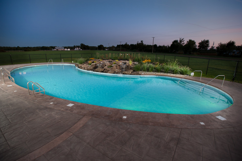 Huge mountain style courtyard stamped concrete and custom-shaped natural pool fountain photo