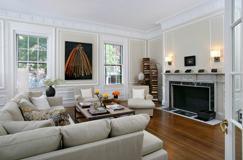 This is an example of a large transitional open concept living room in Boston with medium hardwood floors, a standard fireplace, a stone fireplace surround and beige walls.
