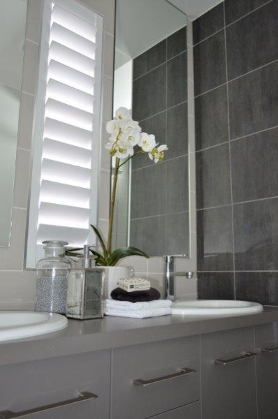 Design ideas for a contemporary bathroom in Townsville with gray tile and grey walls.