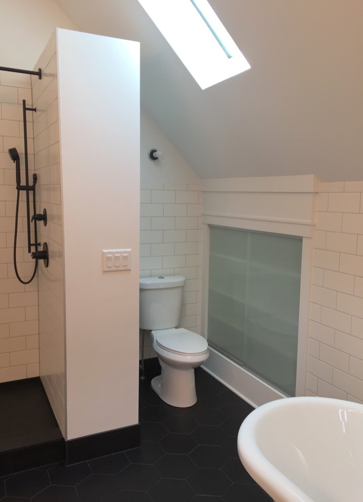 Photo of a mid-sized eclectic master bathroom in Milwaukee with furniture-like cabinets, medium wood cabinets, a freestanding tub, an alcove shower, a two-piece toilet, white tile, ceramic tile, white walls, ceramic floors, a console sink, black floor and a hinged shower door.