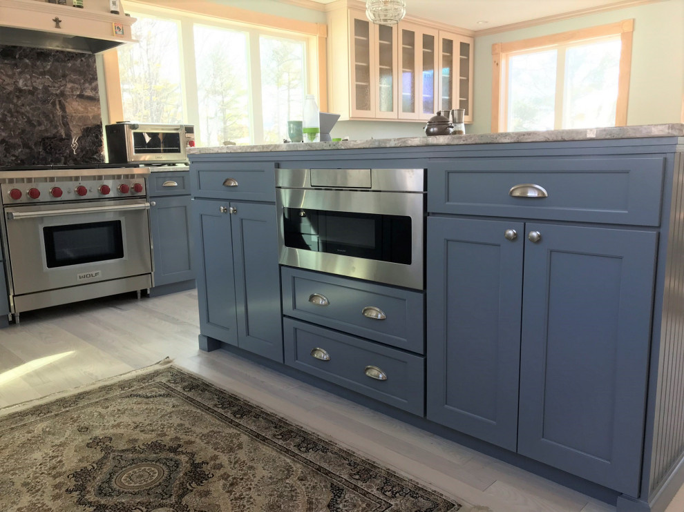 Photo of a large transitional eat-in kitchen in Portland Maine with flat-panel cabinets.