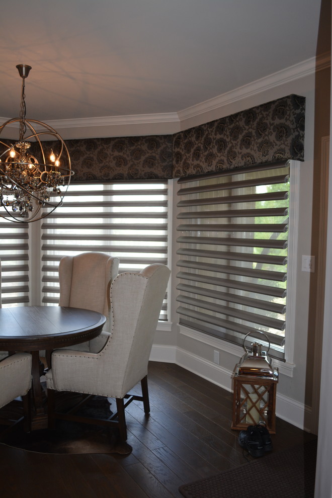 Photo of a mid-sized transitional dining room in Indianapolis with grey walls and medium hardwood floors.