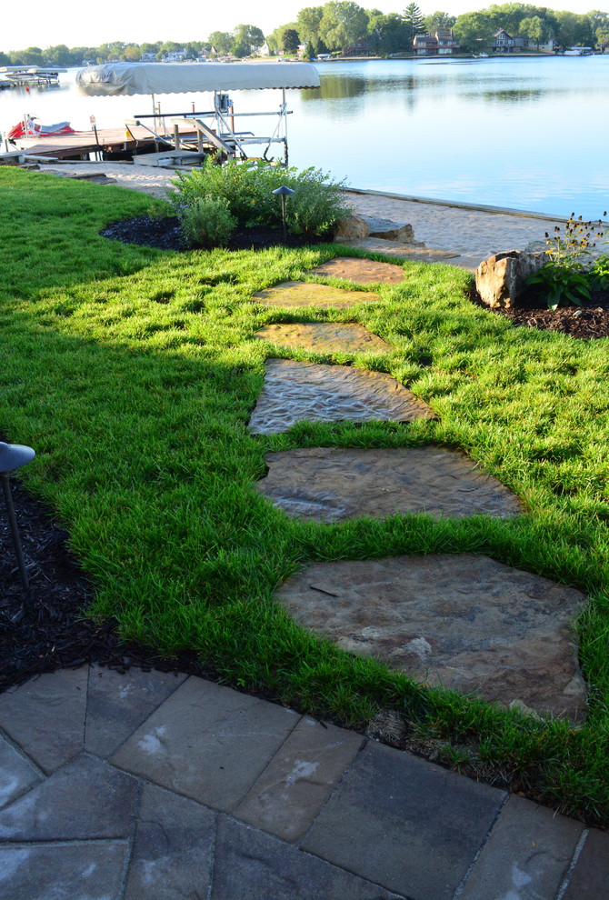 This is an example of a rustic backyard stone garden path in Omaha.