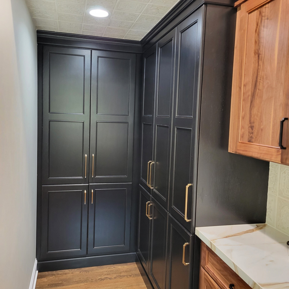 Large transitional medium tone wood floor and brown floor kitchen photo with an undermount sink, recessed-panel cabinets, medium tone wood cabinets, multicolored backsplash, stainless steel appliances, an island and multicolored countertops