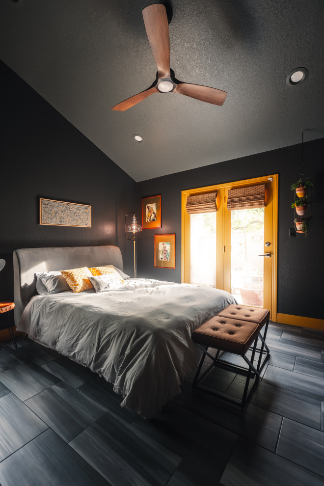 This is an example of a medium sized bohemian guest bedroom in Las Vegas with black walls, porcelain flooring, grey floors and panelled walls.