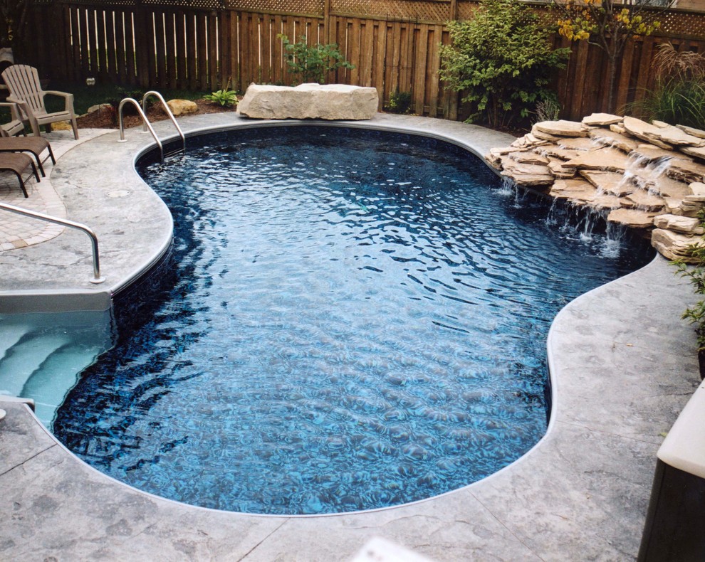Pool - transitional backyard concrete paver and custom-shaped pool idea in Baltimore