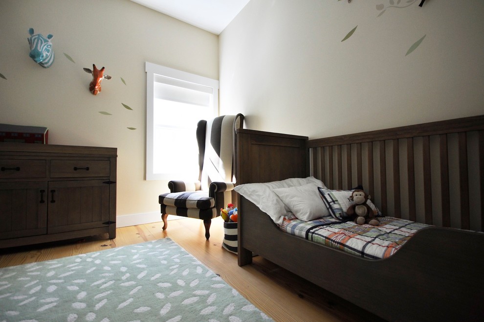 Large country gender-neutral kids' room in New York with beige walls and light hardwood floors.
