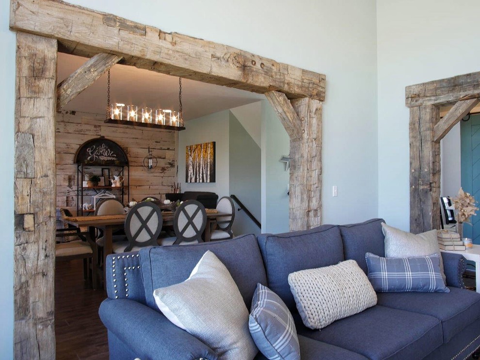 Design ideas for a mid-sized country formal open concept living room in Indianapolis with blue walls, dark hardwood floors, a standard fireplace, no tv and a stone fireplace surround.