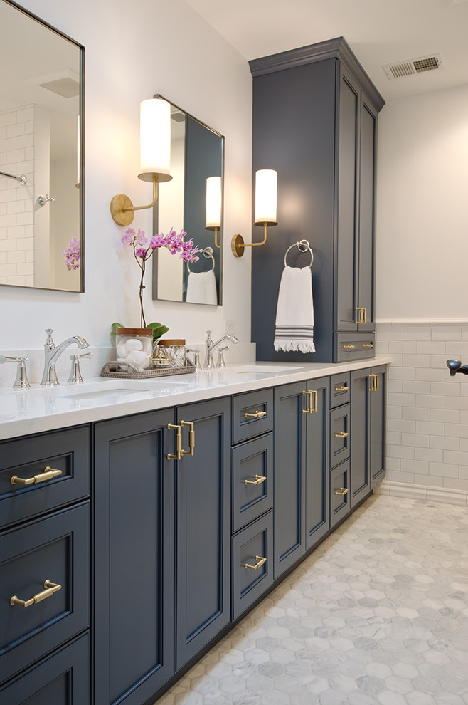 Mid-sized transitional 3/4 bathroom in Chicago with blue cabinets, an alcove tub, an alcove shower, a two-piece toilet, white tile, ceramic tile, white walls, marble floors, an undermount sink, engineered quartz benchtops, white floor, a shower curtain and recessed-panel cabinets.