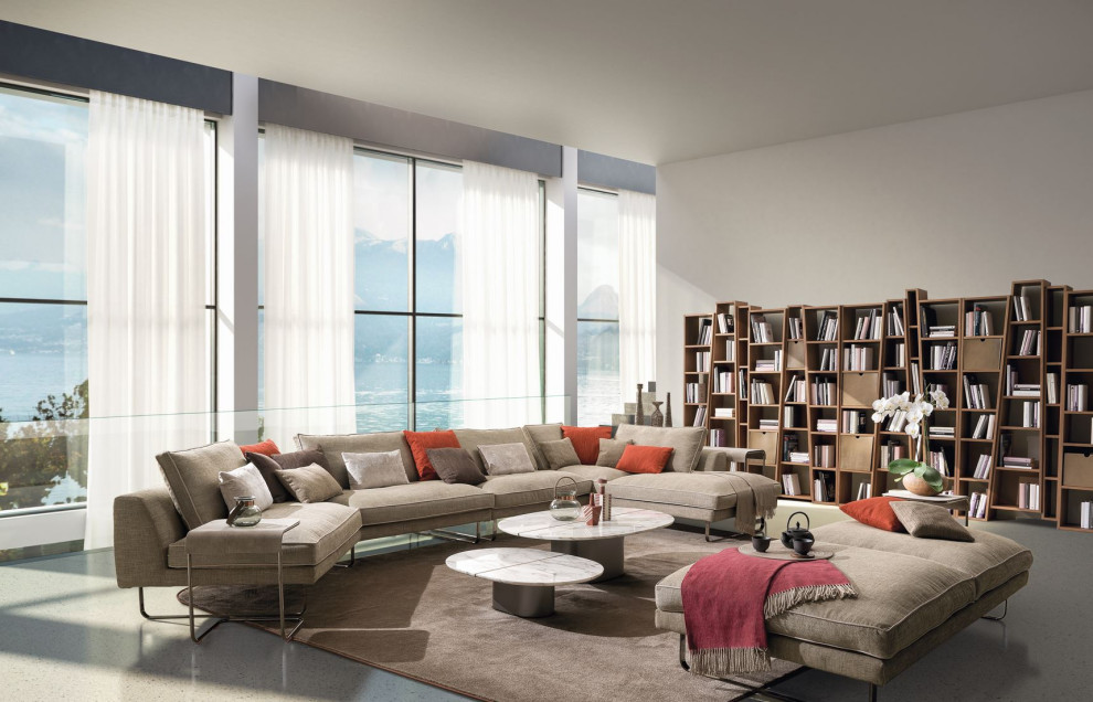 This is an example of a large contemporary open concept living room in Miami with beige walls, concrete floors, no fireplace, no tv and beige floor.