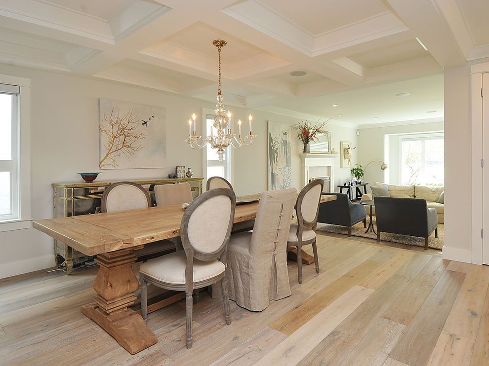 Inspiration for a traditional dining room in Vancouver with white walls and light hardwood floors.