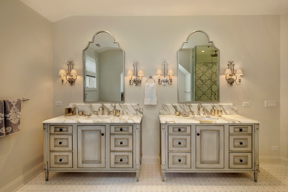Photo of a large traditional master bathroom in Chicago with raised-panel cabinets, grey cabinets, a freestanding tub, white tile, ceramic tile, grey walls, ceramic floors, an undermount sink and marble benchtops.