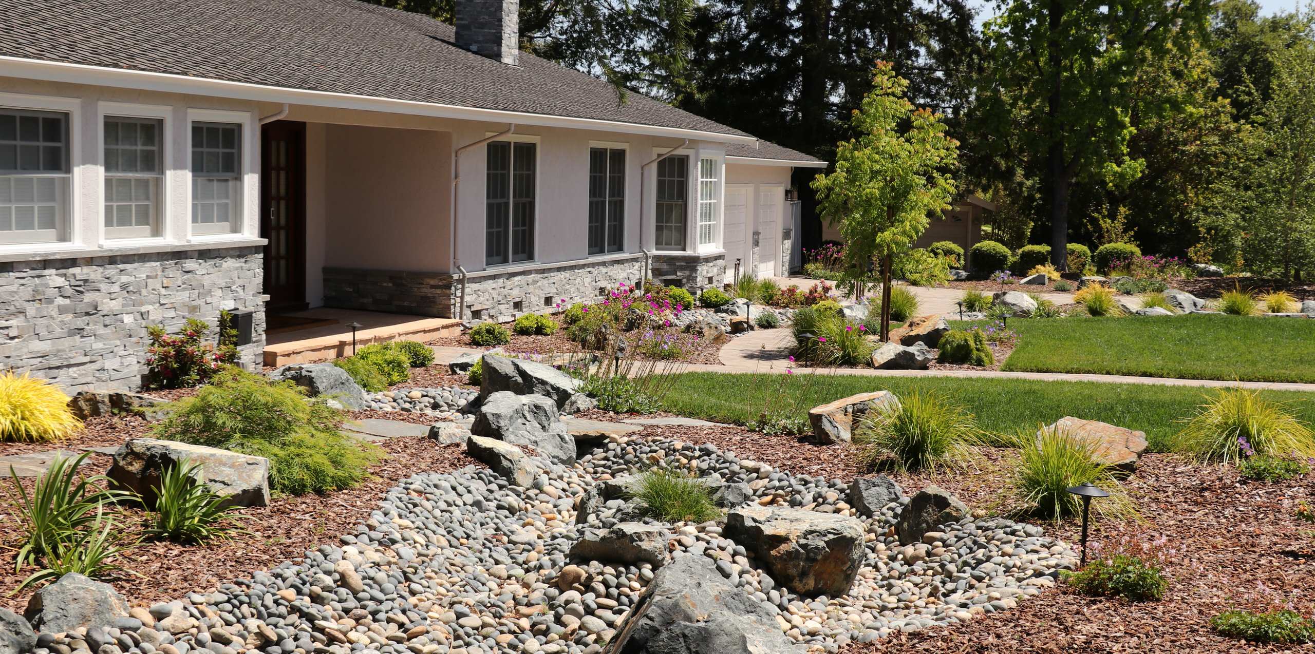 FRONT YARD WITH TREES AND DRY-CREEK