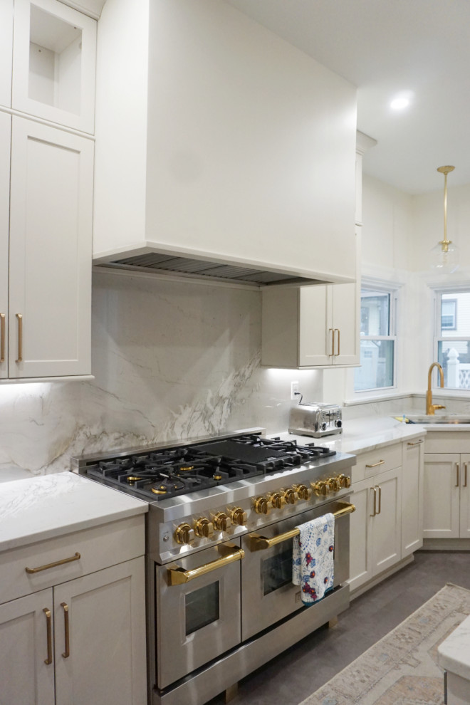 Transitional vinyl floor and gray floor kitchen photo with an undermount sink, shaker cabinets, gray cabinets, quartzite countertops, stone slab backsplash, stainless steel appliances and an island