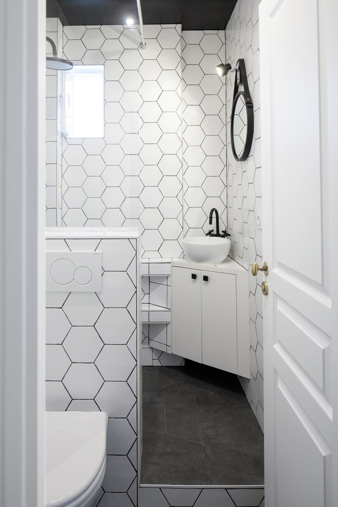 Photo of a 3/4 bathroom in Paris with flat-panel cabinets, black cabinets, an open shower, a wall-mount toilet, black and white tile, cement tile, multi-coloured walls, a vessel sink, tile benchtops, grey floor and an open shower.