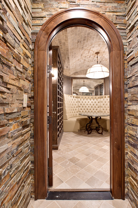 Inspiration for a large traditional wine cellar in Atlanta with travertine floors.