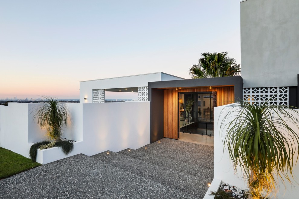 Design ideas for a modern front door in Gold Coast - Tweed with grey walls, concrete floors and grey floor.