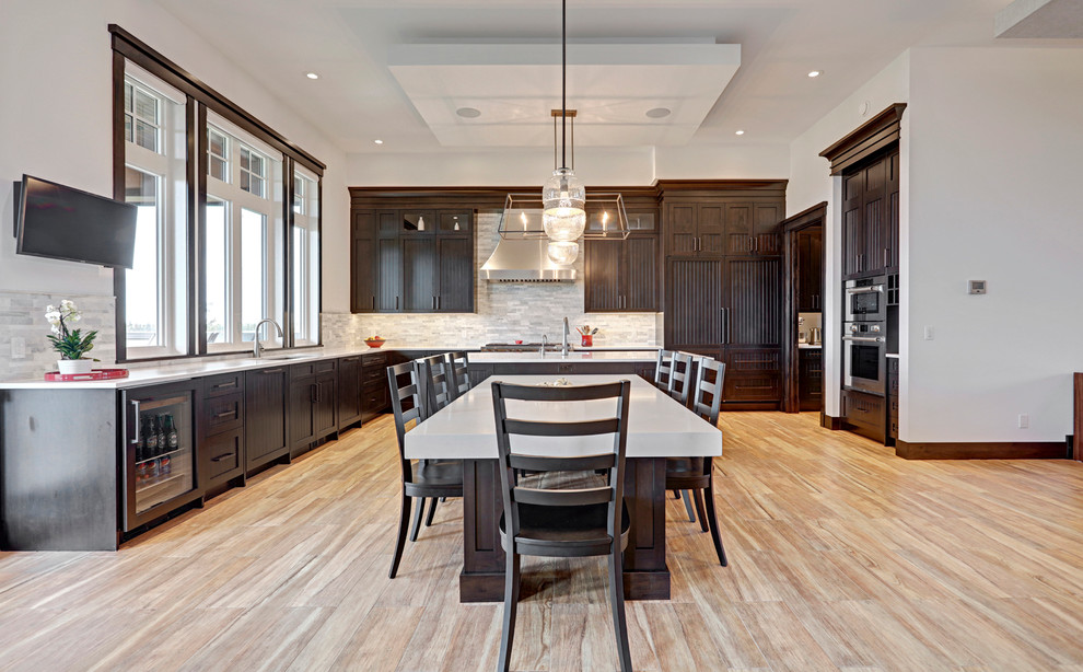 Kitchen - transitional porcelain tile kitchen idea in Calgary with an undermount sink, shaker cabinets, dark wood cabinets, quartzite countertops, multicolored backsplash, stainless steel appliances and an island