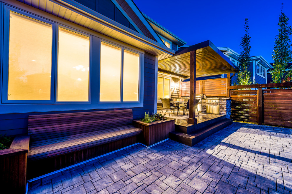 Inspiration for a mid-sized transitional backyard deck remodel in Calgary with a pergola