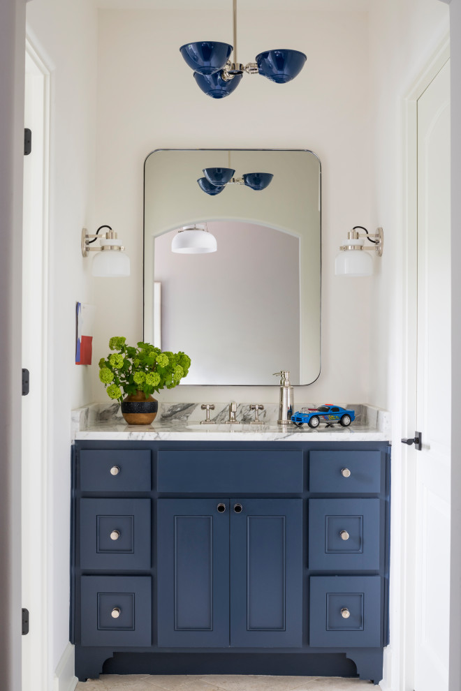 Photo of a small transitional kids bathroom in Austin with blue cabinets, engineered quartz benchtops, white benchtops, a single vanity, a built-in vanity, shaker cabinets, white walls, an undermount sink and beige floor.