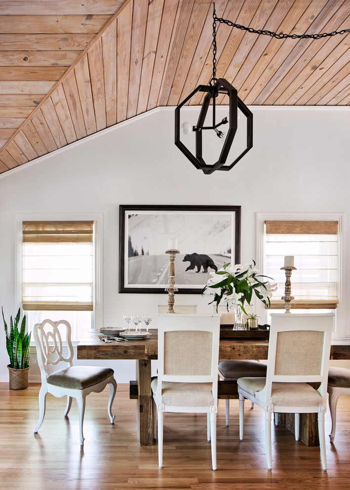 Inspiration for a transitional dining room in Miami with white walls, medium hardwood floors and brown floor.