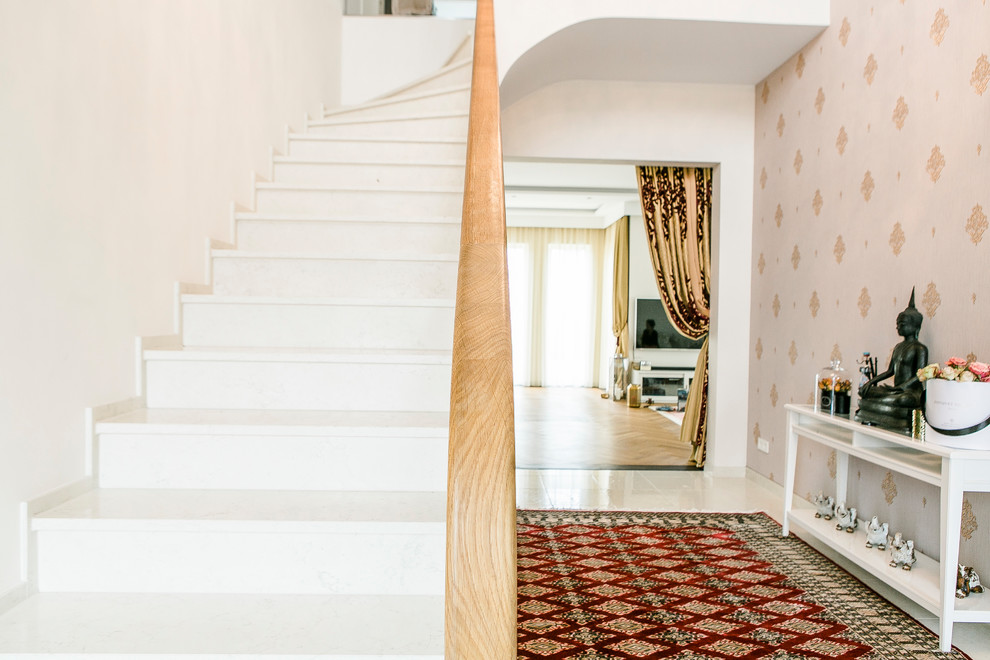 Inspiration for a mid-sized asian foyer in Berlin with marble floors, white walls and beige floor.