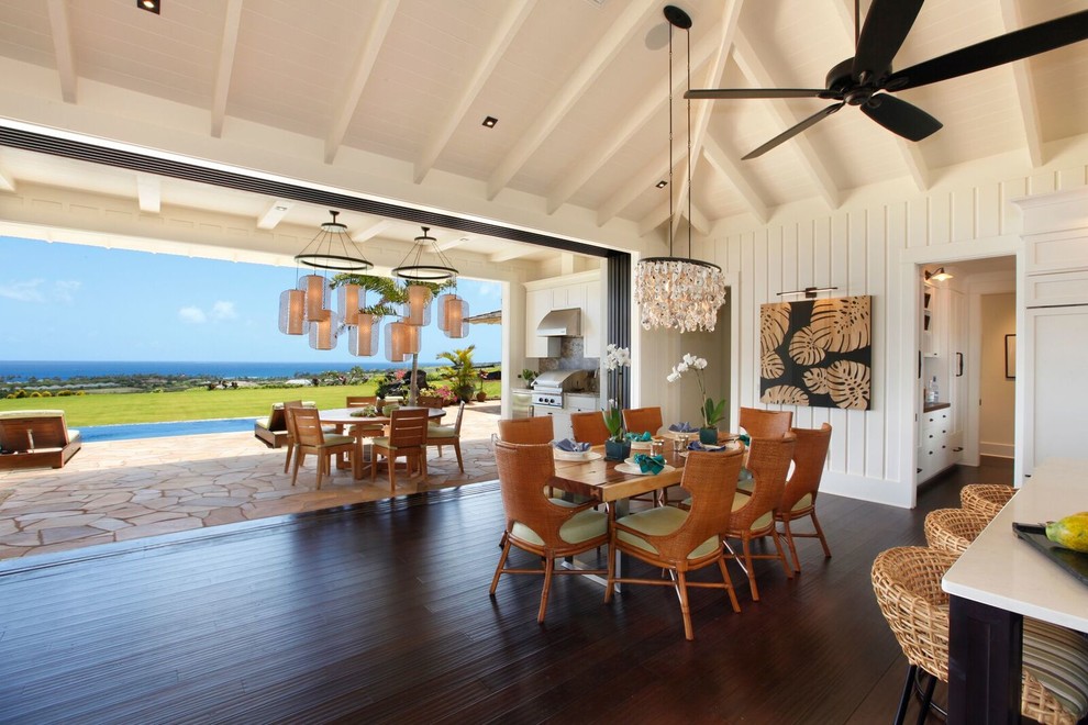 Inspiration for a mid-sized beach style open plan dining in Hawaii with white walls, bamboo floors, black floor and no fireplace.