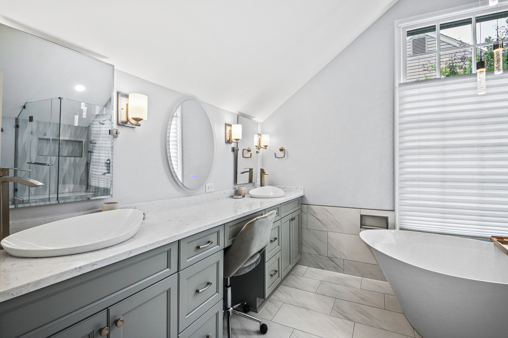 Photo of a large traditional ensuite bathroom in DC Metro with recessed-panel cabinets, grey cabinets, a freestanding bath, a corner shower, a vessel sink, engineered stone worktops, a hinged door, a shower bench, double sinks and a built in vanity unit.