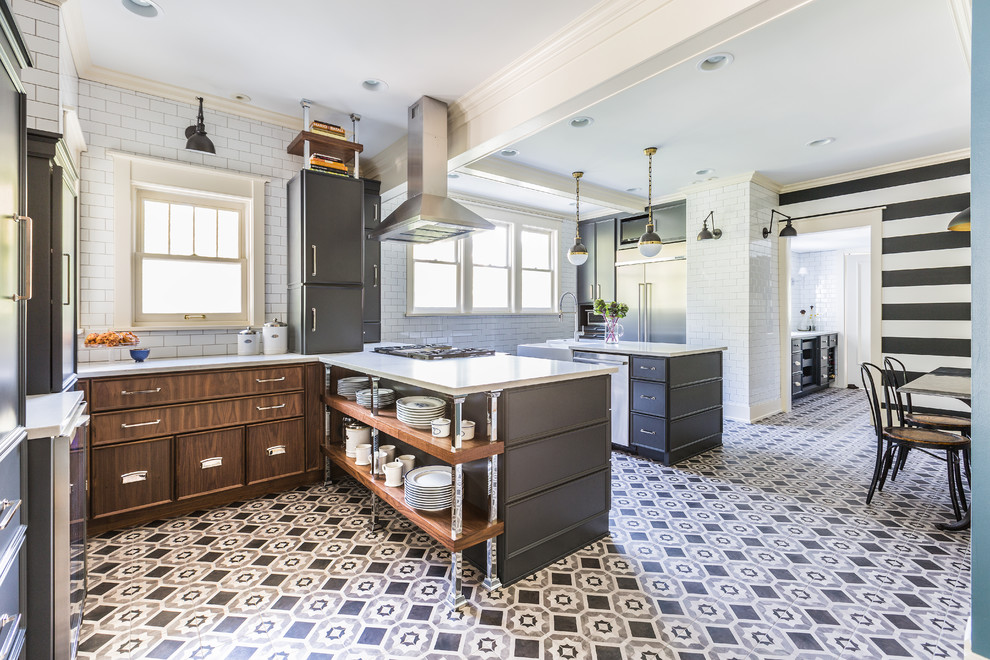 Kitchen - large transitional porcelain tile kitchen idea in Chicago with a farmhouse sink, flat-panel cabinets, gray cabinets, quartz countertops, white backsplash, ceramic backsplash, stainless steel appliances and an island