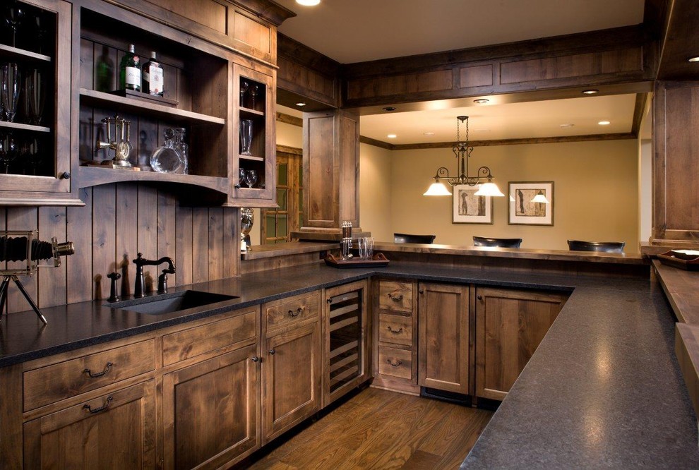 Design ideas for a country u-shaped home bar in Minneapolis with dark hardwood floors, an undermount sink, shaker cabinets, dark wood cabinets and brown floor.