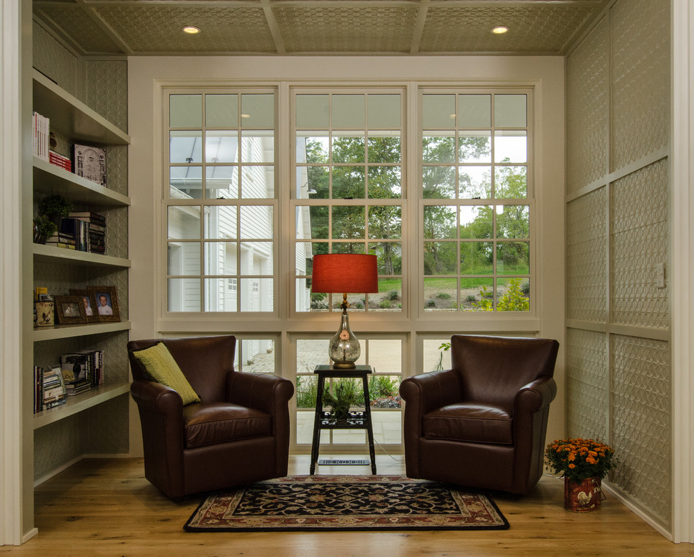 Photo of a small country sunroom in DC Metro with light hardwood floors.